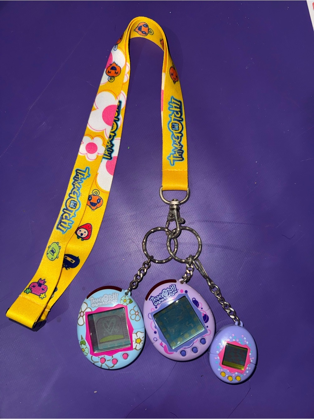 3 vintage tamagotchis with lanyard from early 2000s